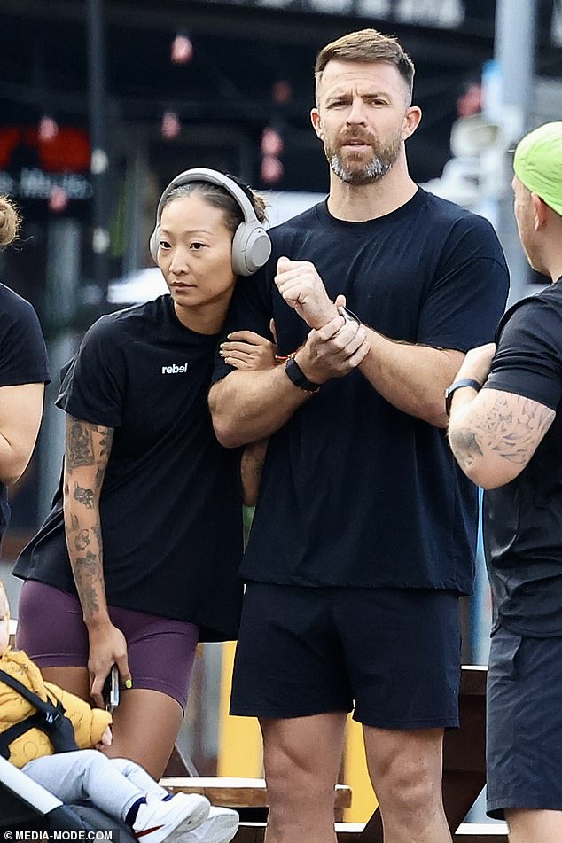 Wrapping herself around Todd's arm, the influencer looked sporty and chic in a black t-shirt from the brand and skin-tight purple biker shorts.