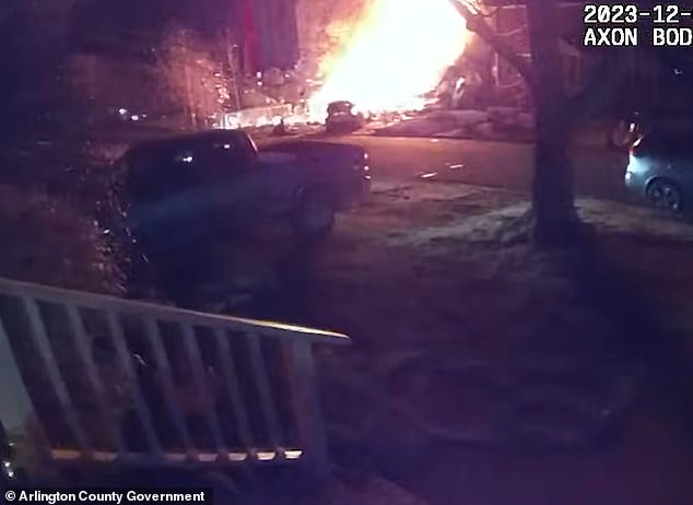 A police officer in a nearby driveway witnesses the explosion at Yoo's house that engulfs a police car parked on the lawn.