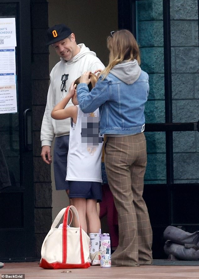 The Ted Lasso creator star, 48, smiled at his seven-year-old daughter, Daisy Josephine Sudeikis, as the Independent Spirit Award-winning filmmaker, 40, fixed her ponytail before a sporting event.