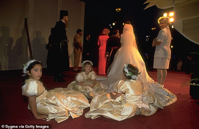 The young bridesmaids wore gold dresses with puffed sleeves and flower crowns.