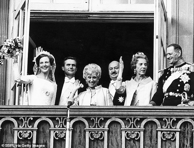 The newlyweds were accompanied by their delighted parents on the balcony.