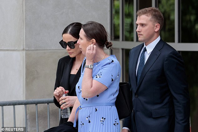 Naomi Biden, dressed in black at left, is followed out of the courthouse in Wilmington, Delaware, by her husband Peter Neal.