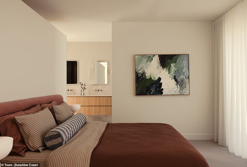 The luxurious master bedroom has an open bathroom adorned with marble and Japanese tiles that leads to a huge walk-in closet.