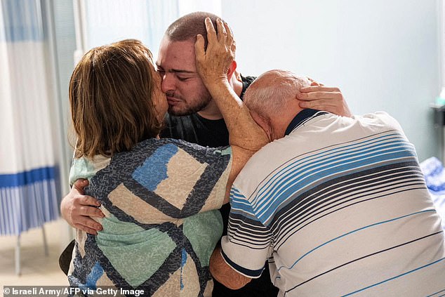 Almong Meir Jan, 22, is seen crying while being welcomed by his close relatives at the Sheba Tel-HaShomer Medical Center, after his rescue from the Gaza Strip by the Israeli army on Saturday.