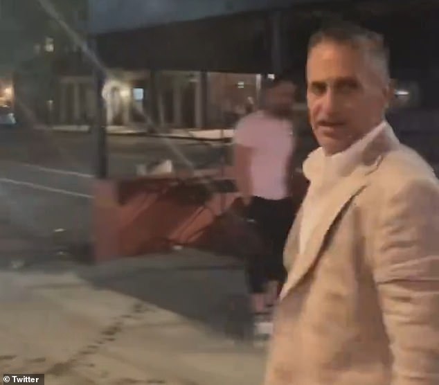 The banker, seen here turning triumphantly after the attack, works as a managing director at Moelis & Company, a leading investment bank with offices in Midtown Manhattan.