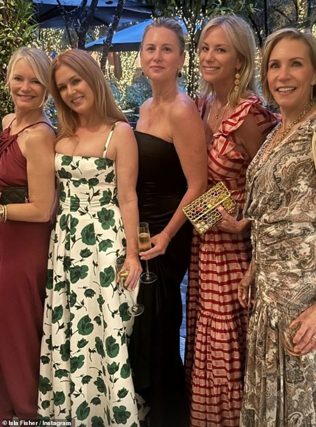 Isla looked incredible in a long white and green floral dress that showed off her ample cleavage and tiny waist while out partying with her friends.