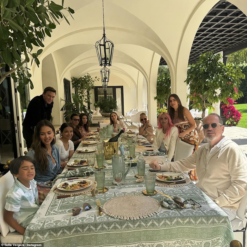 A beautiful table was set up outside with a green and ivory tablecloth, green crystal glasses and gold cutlery.