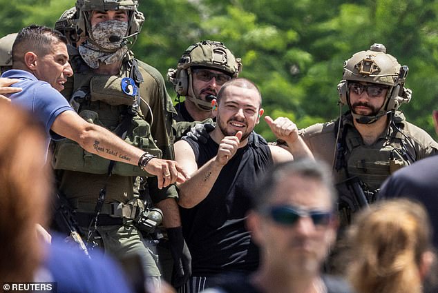 Meir is seen giving a thumbs up shortly after his release while surrounded by IDF soldiers.