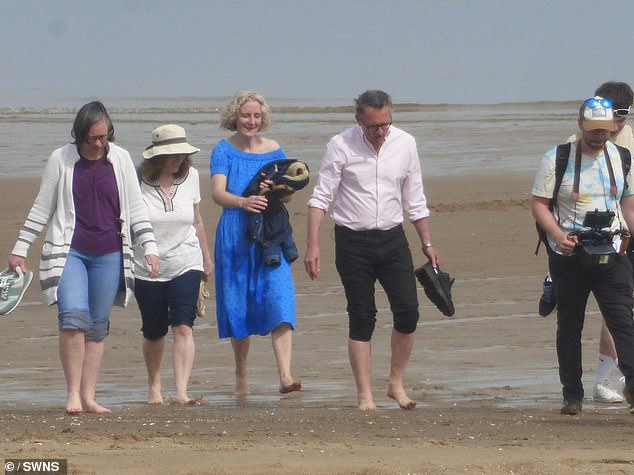 Dr Mosley pictured with his wife Clare filming in Colwyn Bay, Wales, on May 10, just weeks before his death.