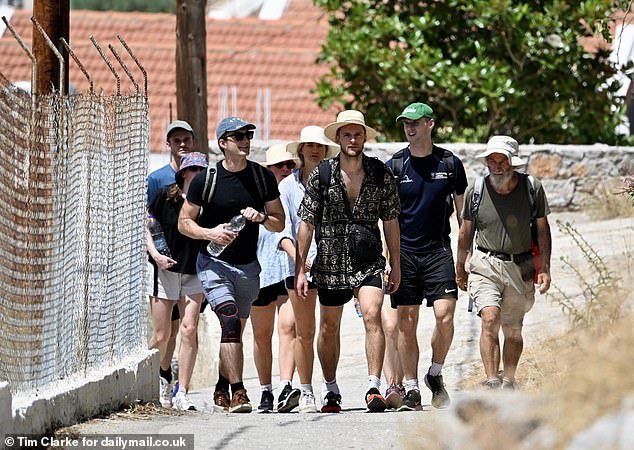 Young British volunteers and family friends walk along the road to Agua Marina near Pedi on Friday as they searched for Dr Mosley.