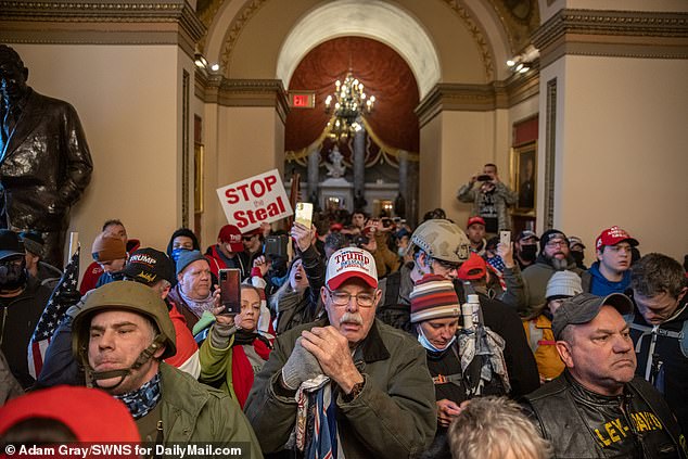 The January 6 rioters are shown above standing outside the House chamber.