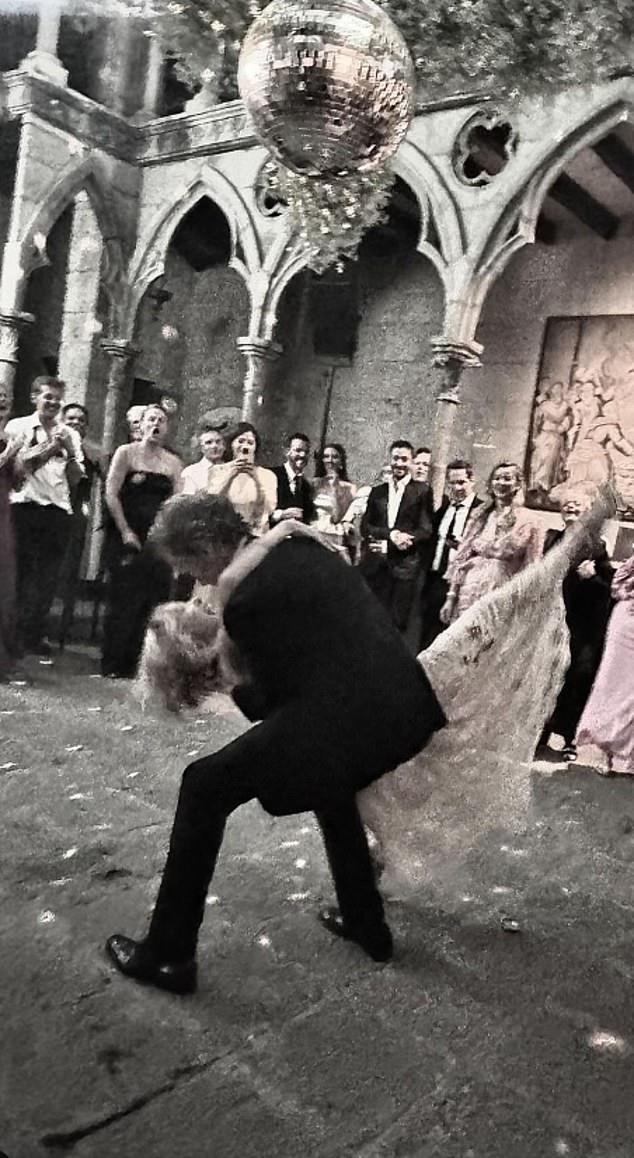 The couple danced the night away under a disco ball.