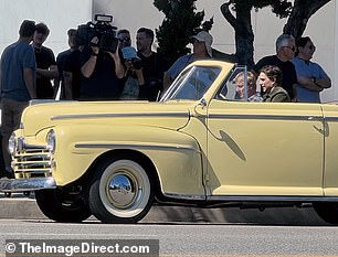 In another scene, the enemies share a ride in the classic yellow Ford convertible, once driven by Daniel's mentor, Mr. Miyagi.