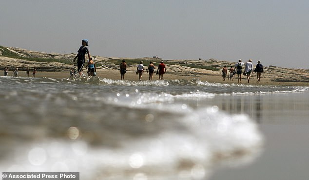 Climate change played a role in the episode at Popham Beach State Park, Maine's busiest state park beach, officials with the state Department of Agriculture, Conservation and Forestry said. Pictured is a file photo of beachgoers enjoying the low tide at Popham Beach State Park.