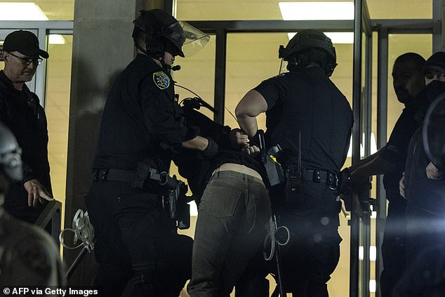 Protester dragged into Dodd Hall after being arrested