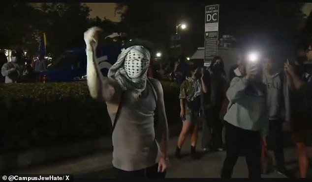 During the nighttime melee, a rabbi filmed himself being threatened by masked protesters.