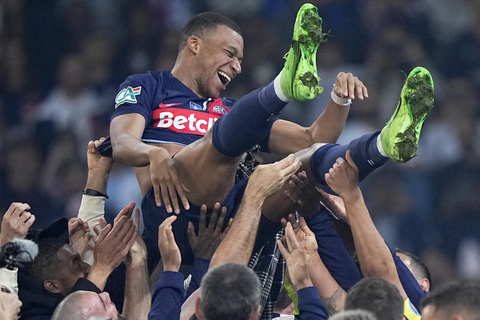 FILE - PSG's Kylian Mbappé is thrown into the air as he celebrates with his teammates after the French Cup final between Lyon and PSG in Villeneuve d'Ascq, northern France, Saturday, May 25, 2024. Mbappé leads France in the Euro 2024 group against teams it loves to score against. (AP Photo/Michel Euler, File)