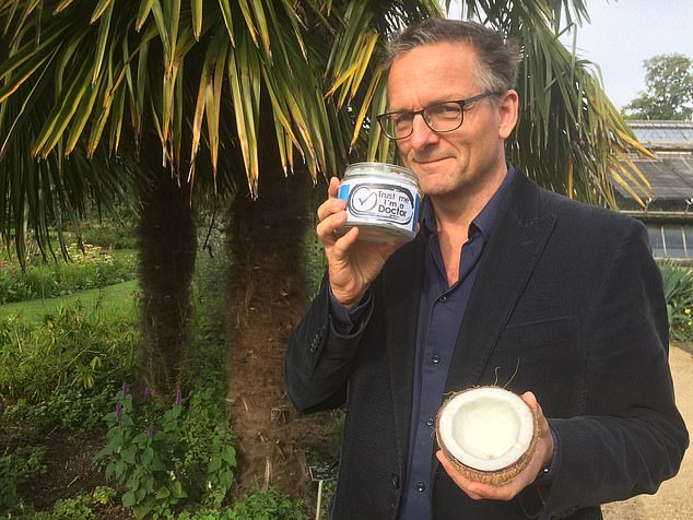 Mosley pictured on Trust Me, I'm A Doctor, a BBC health programme, holding a bottle of coconut oil and a coconut.