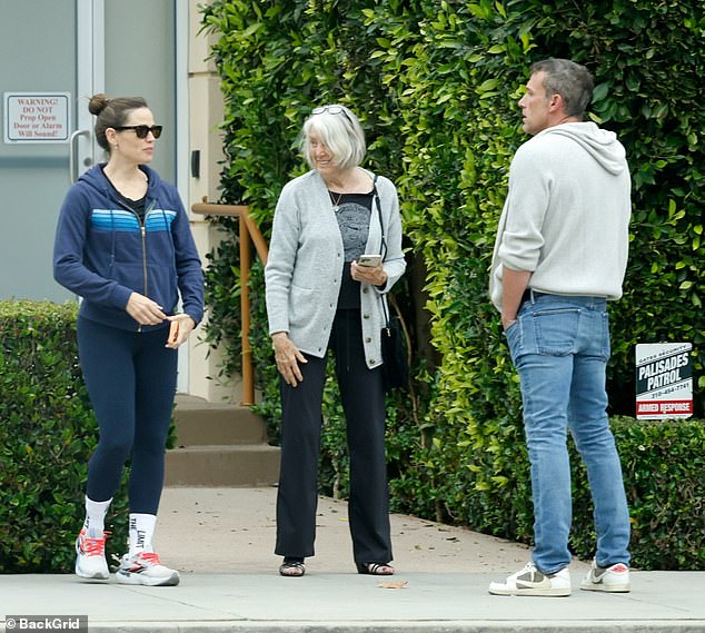 Ben was wearing a gray sweater over a burgundy t-shirt, jeans, and his usual Nike sneakers.