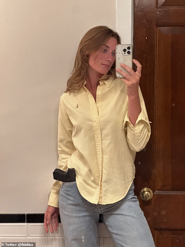 Gaddis photographed with a gun in her pocket, wearing a yellow button-down shirt and jeans.