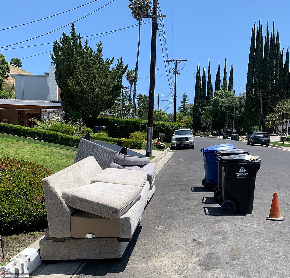 Some of the home's furniture, such as a taupe sectional sofa that had appeared in previous real estate images of the property, can now be seen broken and dirty on the street, ready to be picked up by waste management.