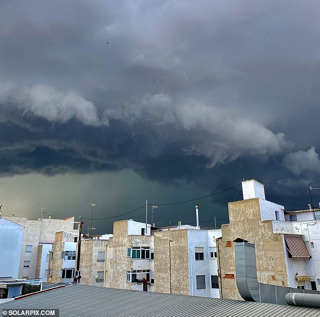 Storm clouds are seen over the city of Murcia as the region is hit by rain and flooding