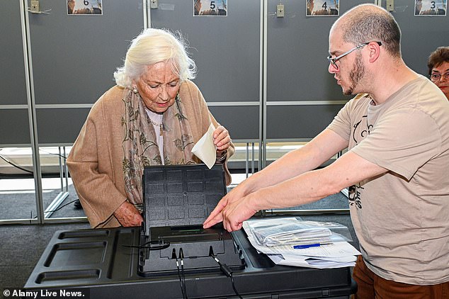 In the photo: Queen Paola of Belgium presents her ballot on Sunday at the Laeken polling station in Brussels.