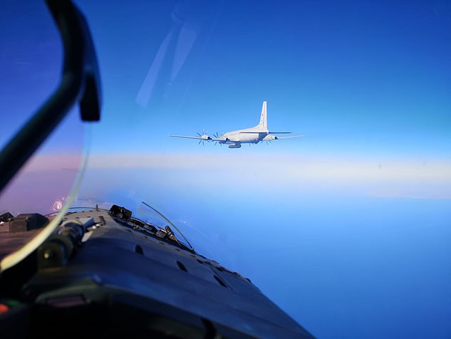 A Russian aircraft seen from the cockpit of a NATO fighter jet heads to intercept an Ilyushin-IL20M spy plane.