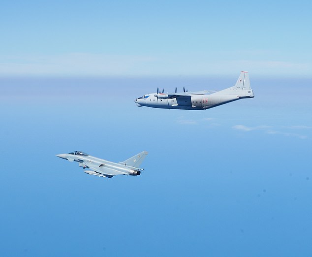 A German Luftwaffe Eurofighter Typhoon is seen flanking a Russian Antonov-AN12 cargo plane over the Baltic Sea.