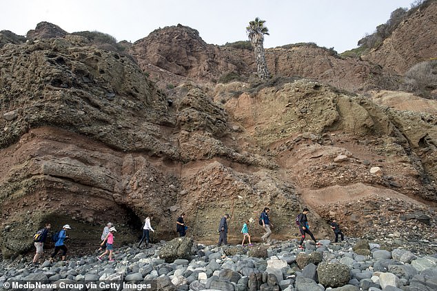 Visitors walk to the tide pools in Dana Point, California