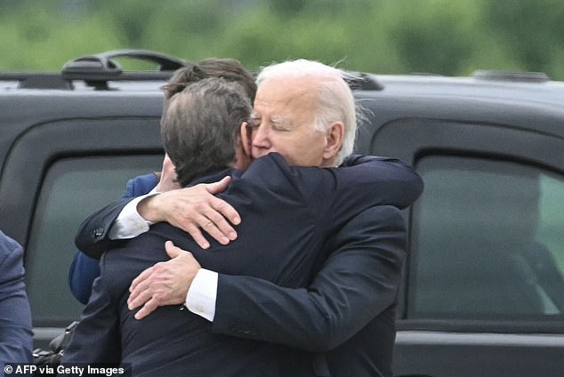 US President Joe Biden hugs his son Hunter Biden upon arrival at the Delaware Air National Guard Base in New Castle, Delaware, on June 11, 2024, hours after the gun conviction by Hunter.