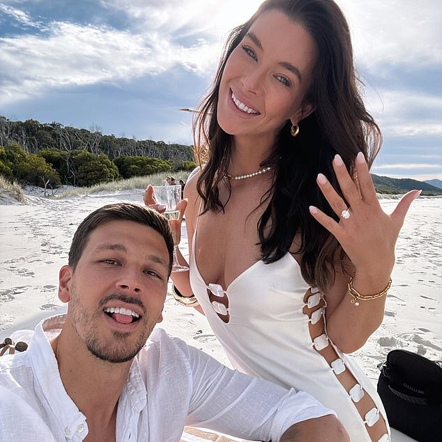 In one of the photos, Brittany appears over the moon as she lights her sparkler while holding a bubble flute on a deserted beach with her fiancé.