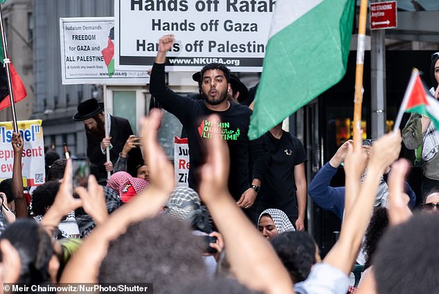 Pro-Palestinian protesters are seen stopping at the Nova Festival exhibit on Wall Street on Monday.