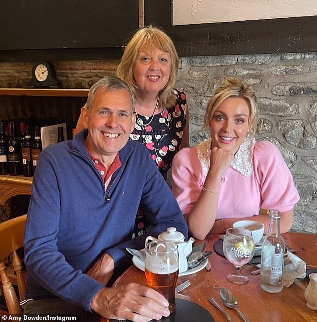 Amy told Richard: 'How different a year can be. Last Father's Day, I just had my mastectomy and your mom was taking care of me and helping me in bed' (Amy pictured with her dad Richard and her mom Gillian)