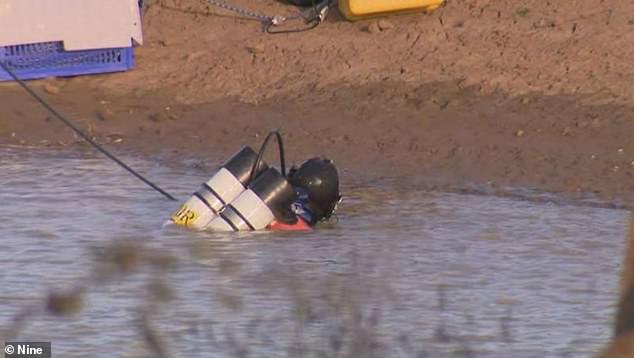 Investigators, including specialist divers (pictured), also found several other items during their search at Buninyong in western Victoria on May 29.