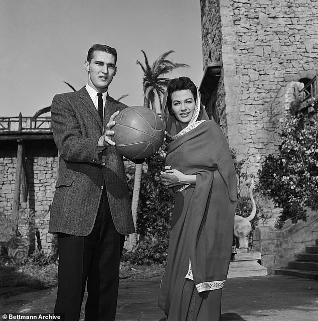 American Jerry West tries to look calm while posing with Yvonne DeCarlo.