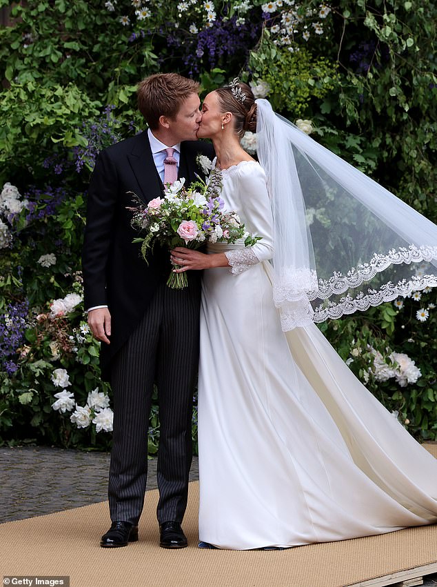 Hugh and Olivia Grosvenor share a heartfelt kiss outside the chapel after getting married on Friday.