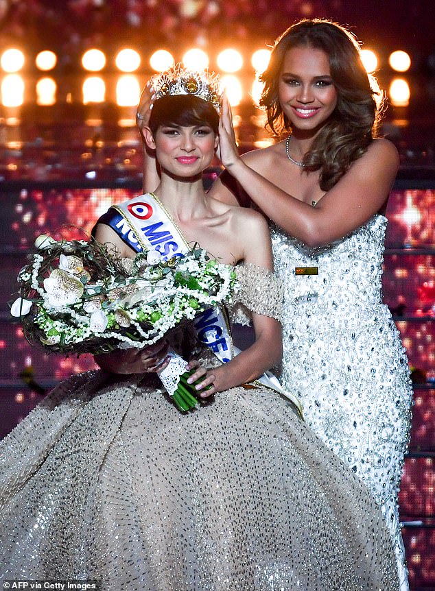 Eve Gilles (left), pictured being crowned Miss France 2024 by Miss France 2023 Indira Ampiot (right), at the Miss France 2024 beauty pageant in Dijon.