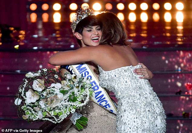 Newly elected Miss France 2024, Miss Nord-Pas-de-Calais Eve Gilles (left), celebrates winning the title with Miss France 2023, Indira Ampiot (R), on stage during the Miss France 2024 beauty pageant in Dijon , central-east. France, December 16