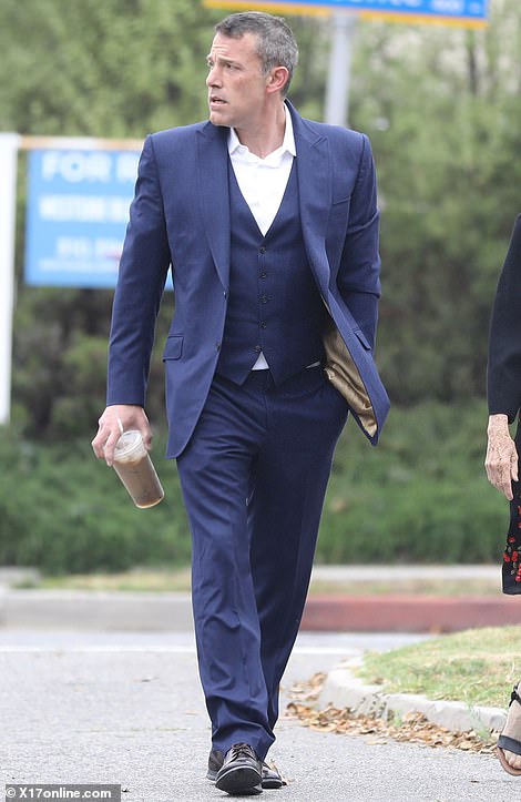 Affleck had a tense expression on his face as he carried an iced coffee.