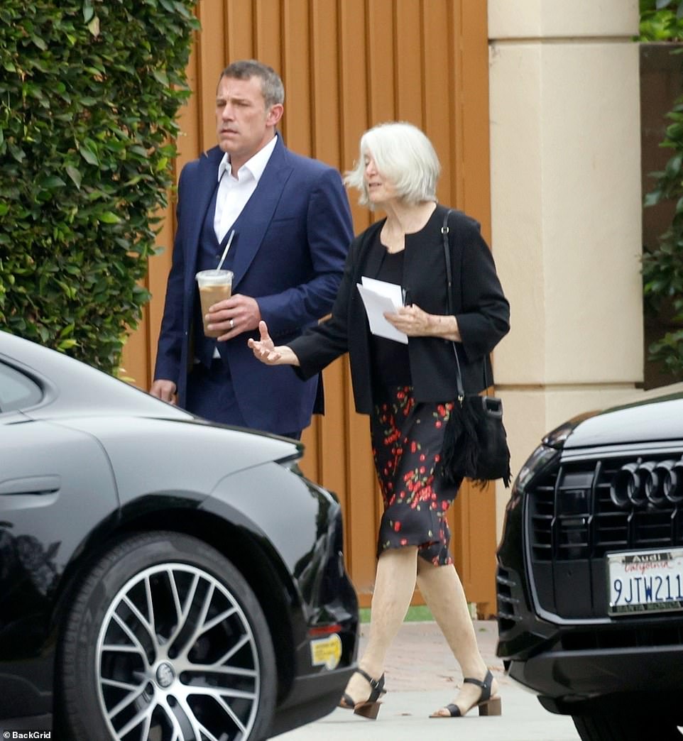 The Argo star showed off her Jennifer gold wedding band on her wedding hand as she walked with her mother, who wore a black skirt with red flowers.