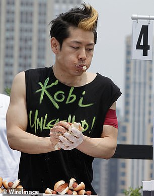 Kobayashi participates in a hot dog eating contest in New York City in 2011.