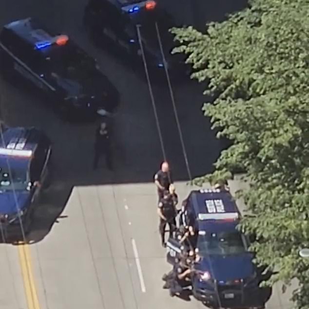 Police cruisers could be seen racing toward the building on Spring Street at 3rd Avenue.