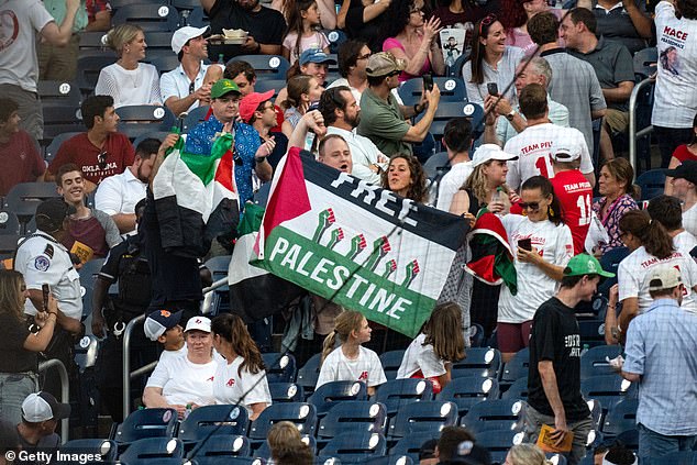 In the stands, pro-Palestinian protesters also displayed flags and chanted, while others booed.