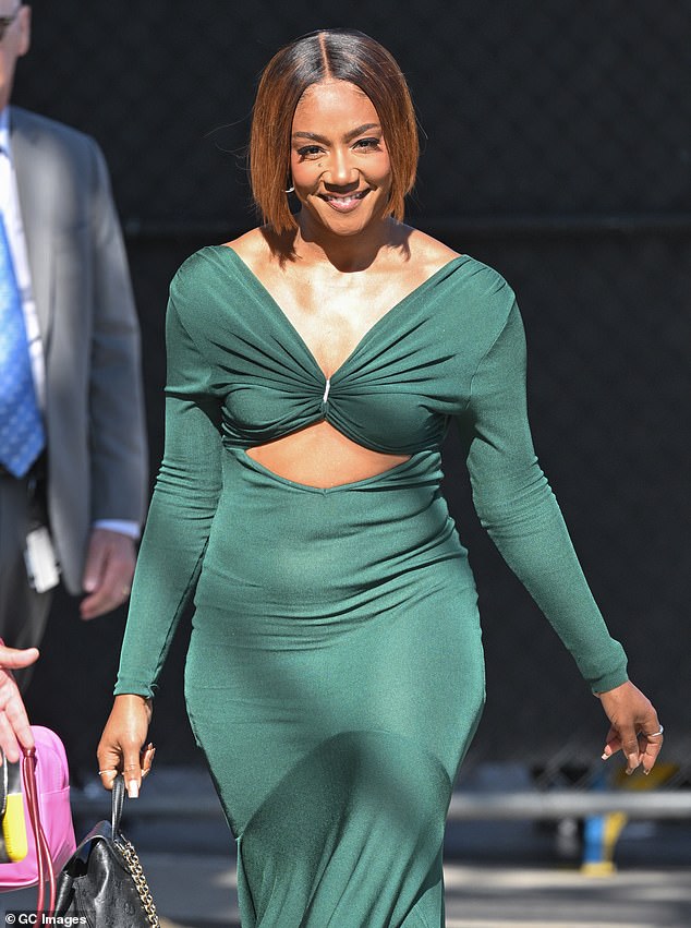 The comedian-turned-singer, 44, showed off her toned tummy in a tight, dark green dress.