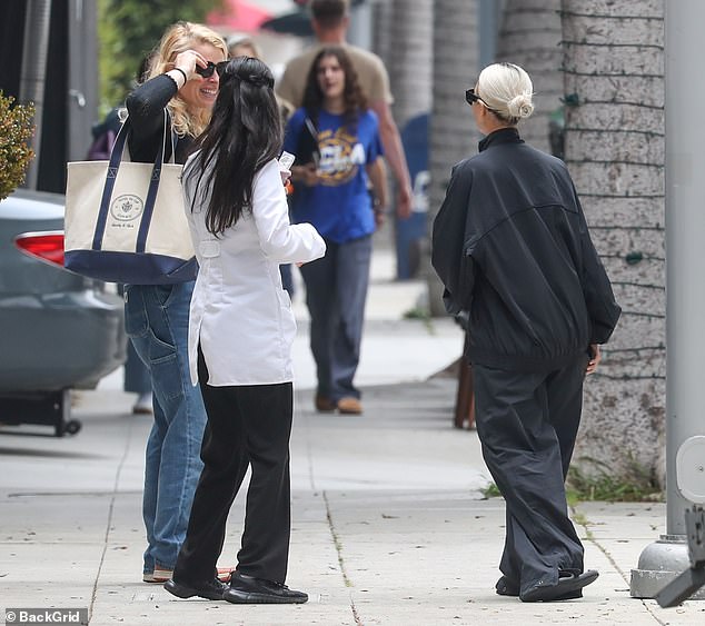 She mingled outside the office before heading to her car.