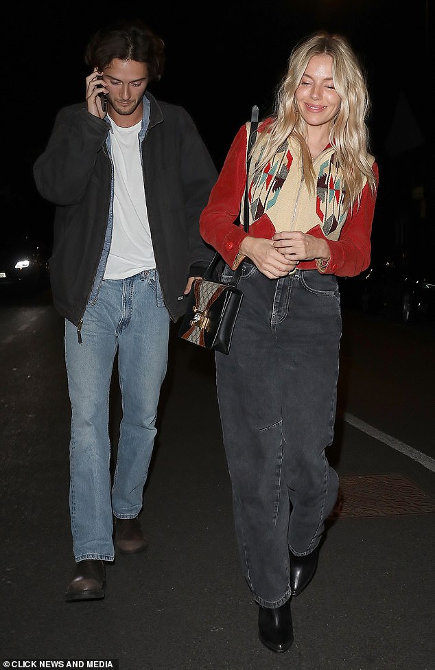 Sienna looked boho chic with carrot leg jeans and an embroidered red jacket