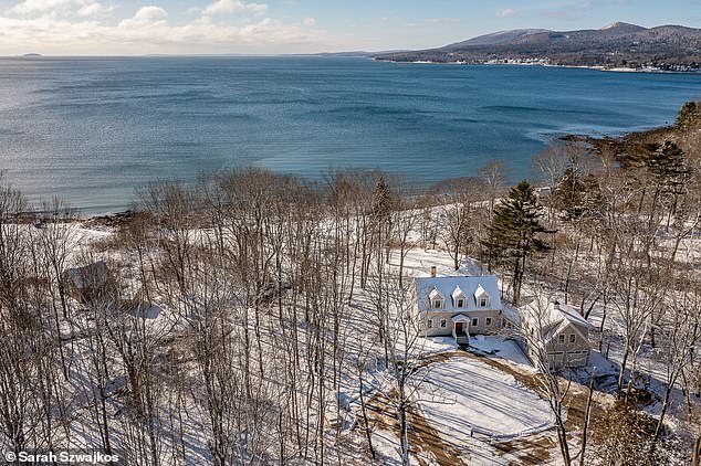 The home is located near a private beach that has 336 feet of ocean frontage and spectacular views of two islands: Camden Hills and Penobscot Bay. (In the photo: The house and the beach in winter)