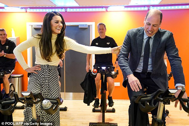 Kate and Prince William battle it out on stationary bikes during visit to South Wales