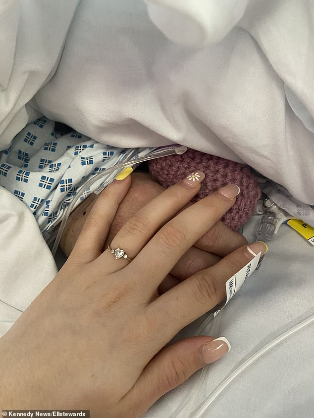 Ellie held her mother's hands after she went into a coma following her heart attack.